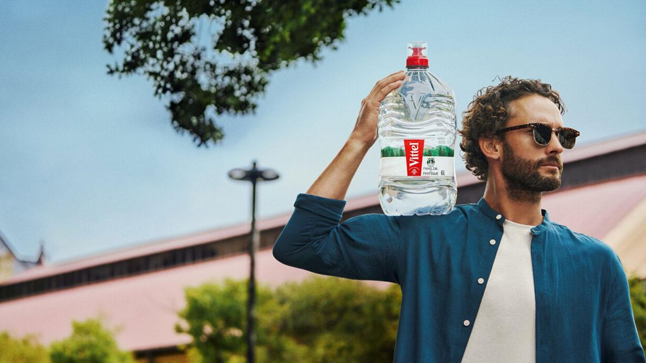 a man with a 6 L bottle