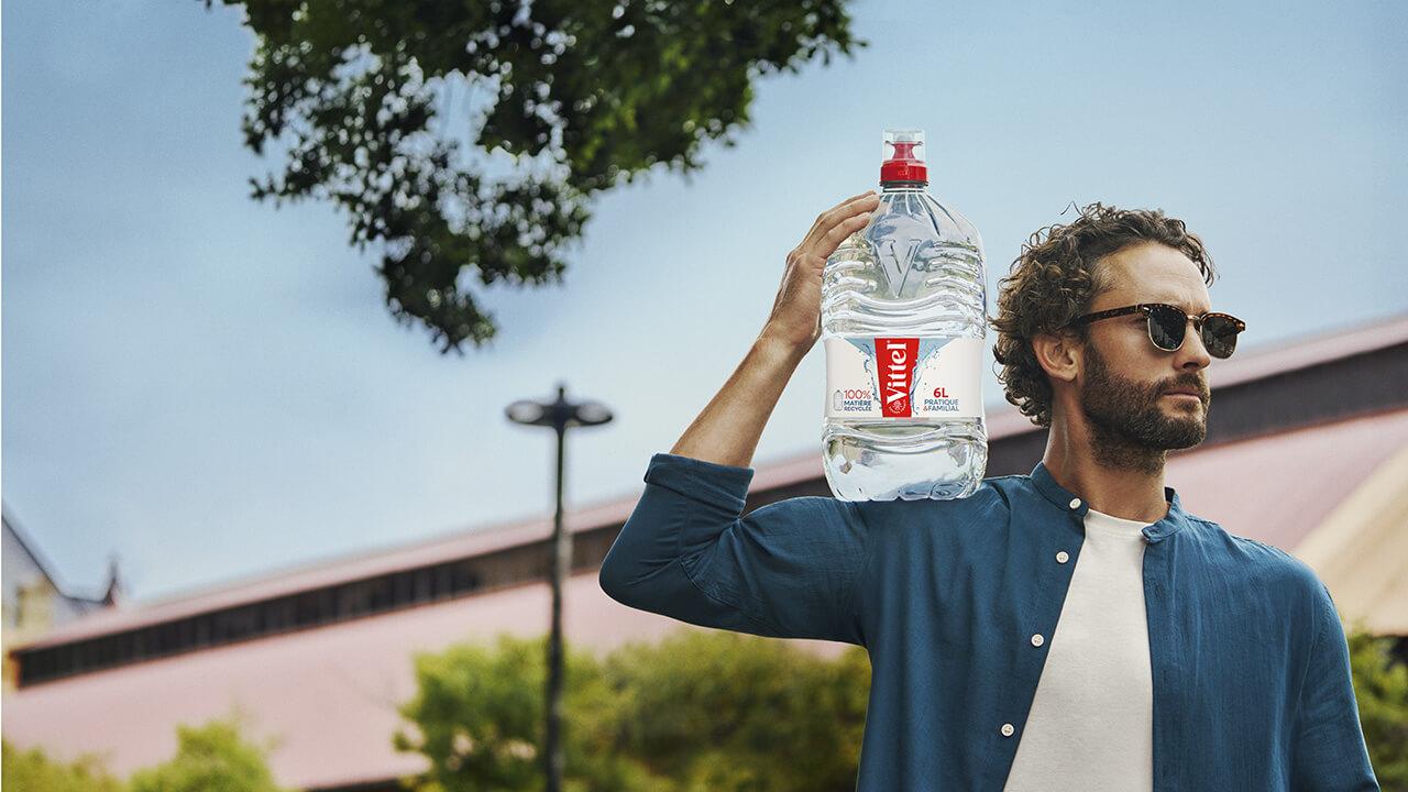 a man with a 6 L bottle