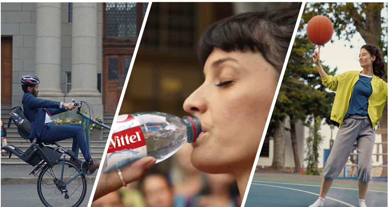 Femme tenant une bouteille Vittel.