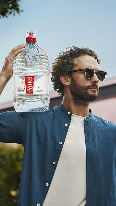 a man with a 6 L bottle