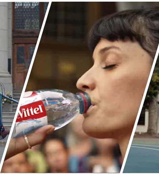 Femme tenant une bouteille Vittel.